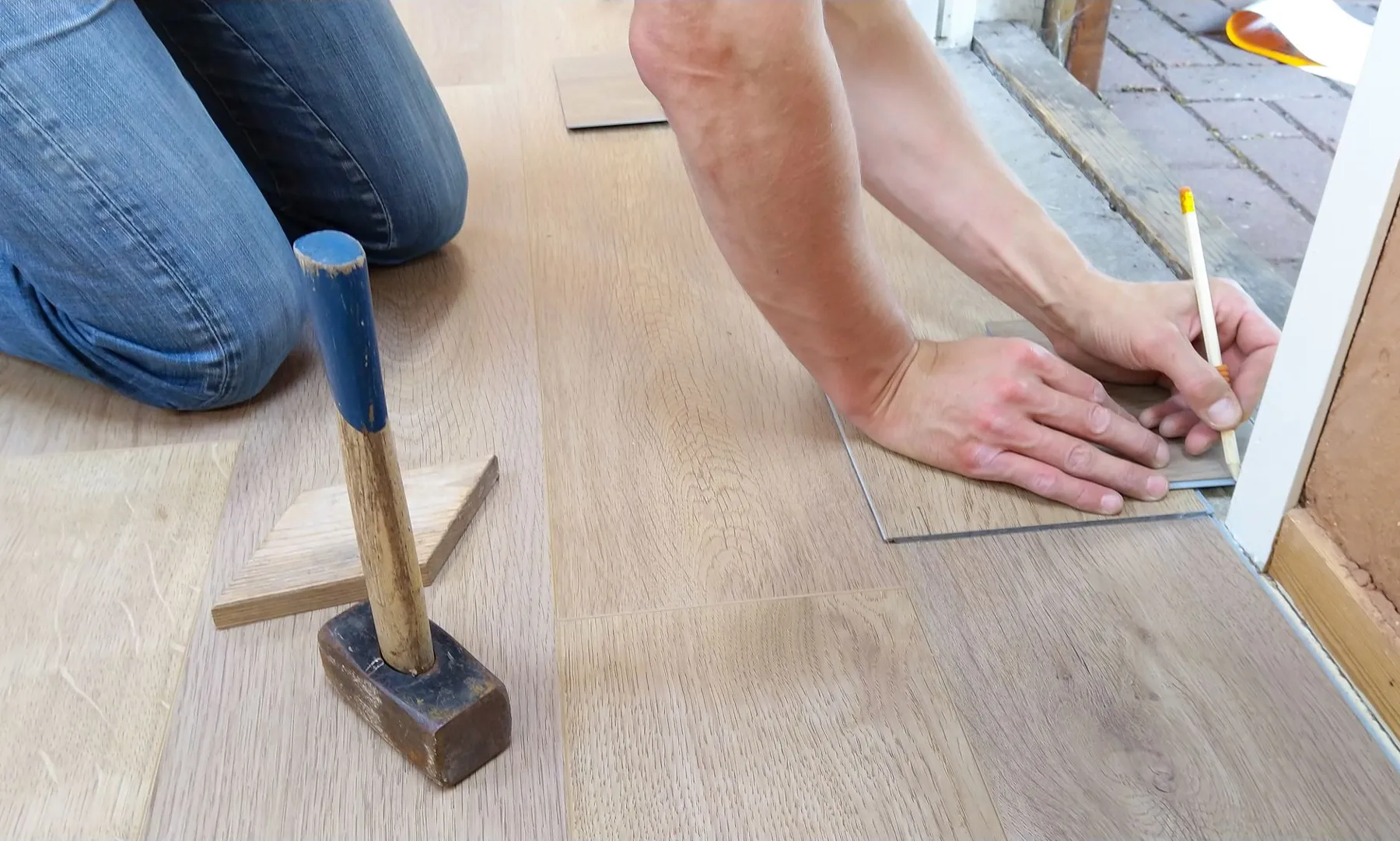 Careful flooring installation — measuring and marking planks